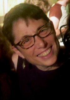 Headshot of Barbara Raab, with short hair and wearing glasses.